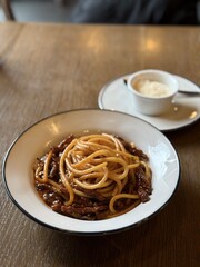 Classic Italian spaghetti with rich meat sauce on restaurant table