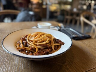 Classic Italian spaghetti with rich meat sauce in cozy restaurant
