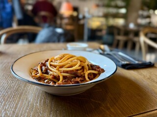 Classic Italian spaghetti with rich meat sauce in cozy restaurant