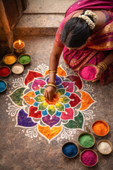a Hindu woman wearing a vibrant sari preparing rangoli patterns with colored powders at the entrance of her home, top-down composition,