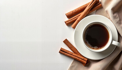 Coffee cup with cinnamon sticks on beige fabric
