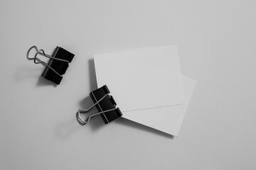 A close-up macro shot of a white paper clip and metallic fasteners organized as essential business...