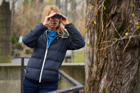 Woman birdwatching with binoculars