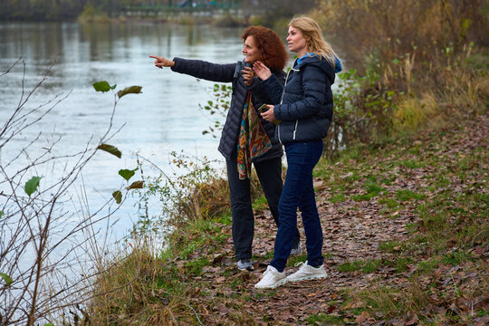 Friends birdwatching by the river