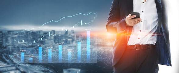 A professional businessman stands outdoors, using a smartphone while surrounded by digital financial graphs and a city skyline, embodying modern corporate success and innovation. Scalp