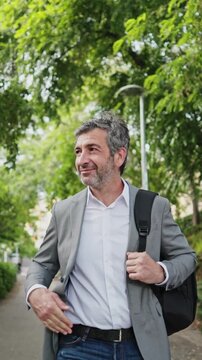 Businessman walking in the park - slow motion montage