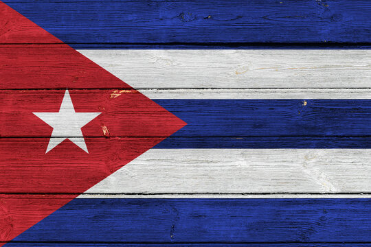 Cuba flag on an old wooden surface with cracked paint.