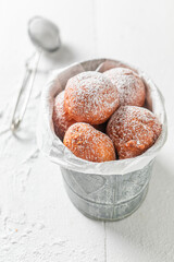 Delicious and sweet mini doughnuts deep frying in oil.