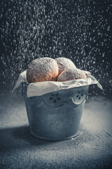 Homemade and fresh mini doughnuts deep frying in oil.