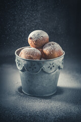 Yummy and hot mini doughnuts deep frying in oil.