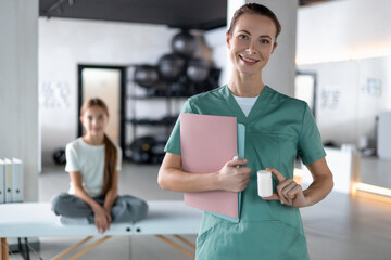 Nurse examining pill bottle for correct dosage