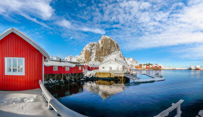 Winter view on Hamnoy village with port and Festhaeltinden mountain on background.