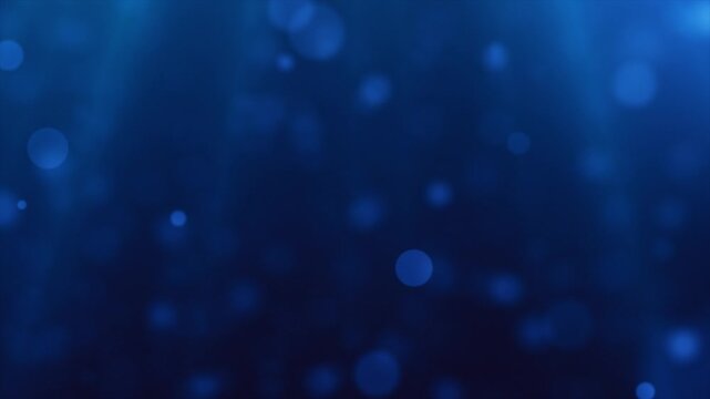 Soft blue bokeh light particles on a deep blue background