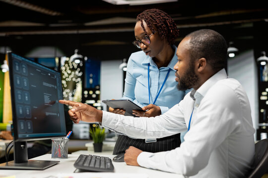 Team of black IT experts use online AI assistant to automate text generation and solve daily tasks, enhance productivity at the office. Integration of advanced algorithms and digital tools.