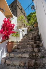Narrow street and stone stairs in old town in Lindos