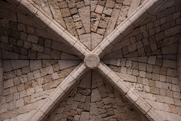Antique ceiling with rose window and cross beams