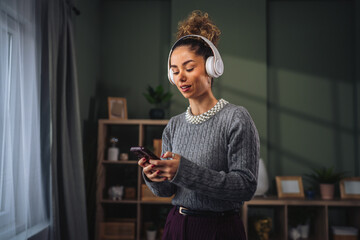 Young woman listening to music relaxing at home