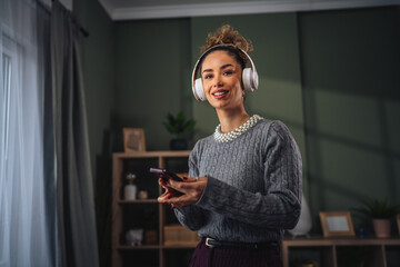 Young woman listening to music relaxing at home
