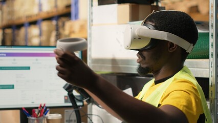 Black warehouse clerk uses virtual reality headset for online shopping orders, preparing cargo...