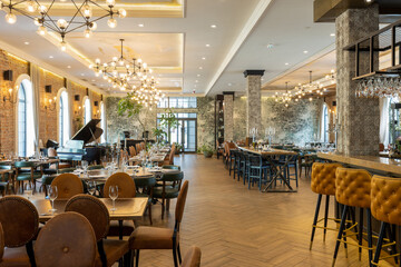 Interior of a quiet hotel restaurant with large brick walls