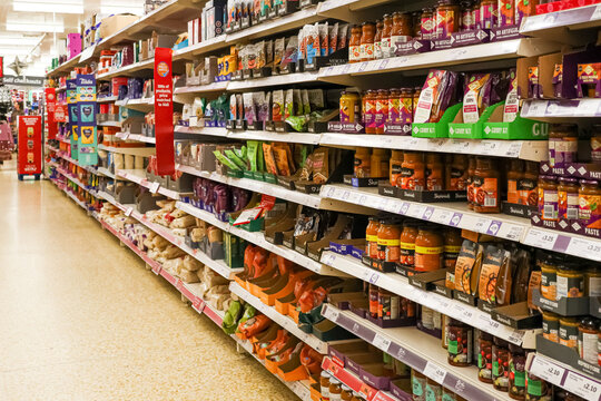 Apsley, England, UK December 12, 2025: Sainsbury's supermarket aisle with shelves full of groceries and food products