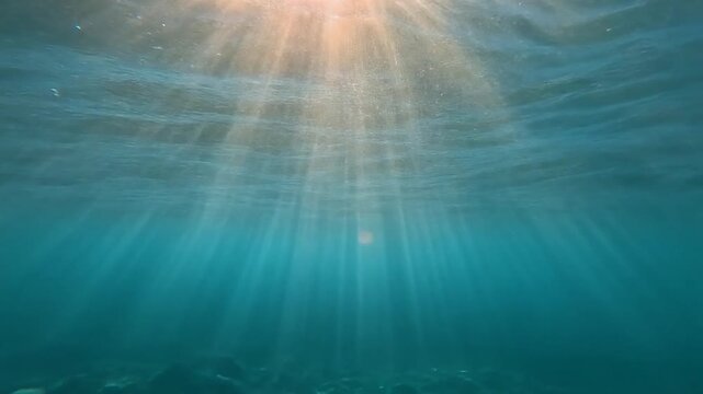 Sunlight Shining Through Calm Ocean Water Surface.