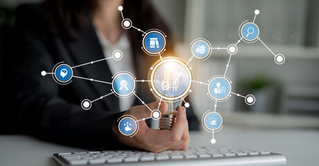 A professional businesswoman engages with digital technology while holding a pen, surrounded by a dynamic data visualization, representing innovation in the modern office. Crux