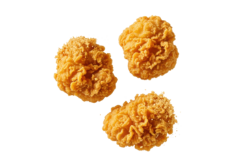 Freshly fried, golden brown chicken nuggets suspended mid-air with an irregular, crispy texture, scattering fine crumbs against a transparent background, conveying irresistible crispiness