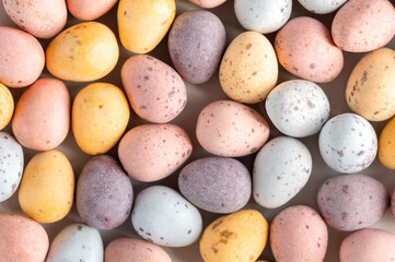 Easter candy chocolate eggs in pastel color. Simple minimalism flat lay top view. Happy Easter concept.