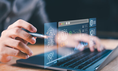 Businessman using CRM dashboard on laptop with digital interface icons represents customer relationship management, data analytics, sales performance, business growth, marketing strategy