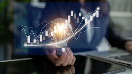 A business professional holds a light bulb symbolizing innovative ideas, while overlaying financial growth charts and analytics in a modern office environment. Impute