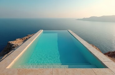Fototapeta premium Infinity edge pool on rocky cliff with sea horizon. Modern architecture, tile finish, turquoise water. Luxury vacation in resort or spa hotel with stunning ocean view. Calm nature landscape.