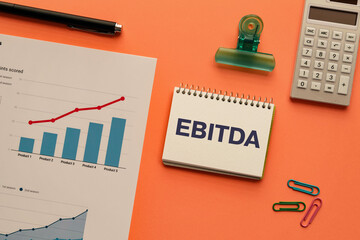 There is sticky note with the word EBITDA. It is an abbreviation for Earnings Before Interest Taxes Depreciation and Amortization as eye-catching image.
