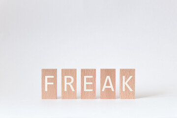 There is wood block with the word FREAK. It is as an eye-catching image.