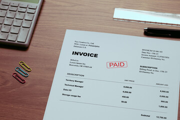A dummy document of the INVOICE is on the desk, along with a calculator and a pen.