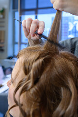Creating beautiful curls in a vibrant salon setting during the afternoon glow