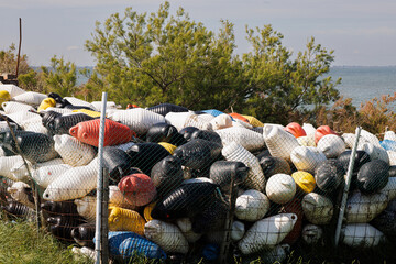 Discarded buoys from mussel farming piled in an outdoor storage area