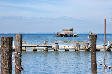 A rustic wooden stilt house and boat with fishing nets