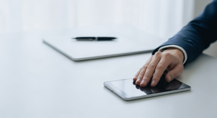 Professional reaching for tablet on white desk, closeup shot with copy space