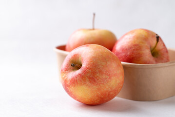 Red apple fruit (Gala apple) in natural bowl on white background
