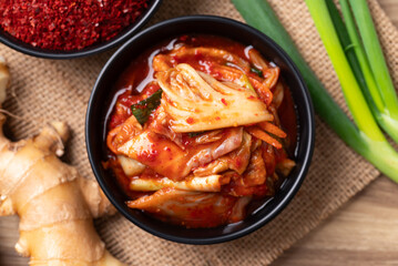 Korean kimchi cabbage in a bowl with ingredients, Table top view