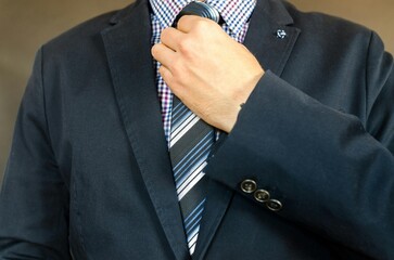 businessman adjusting tie
