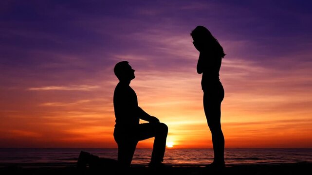 Cinematic wide shot of a silhouetted man proposing marriage to a woman on a beach at sunset.