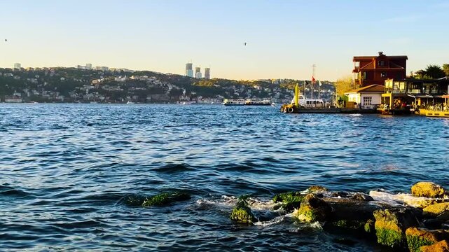 Bosphorus View with Mossy Rocks and Traditional Waterfront Houses in Istanbul