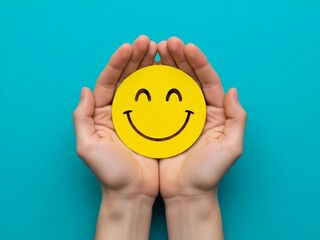 Hands cradling a smiley face on a blue background