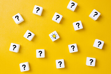 Concept of to find a creative idea or problem solving. Question mark and light bulb icons on dice