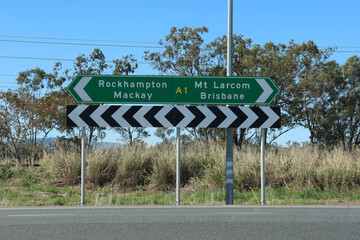 Directional sign pointing towards Rockhampton, Mackay, Mt Larcom and Brisbane on the Bruce Highway in Queensland, Australia
