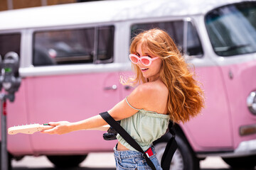 Excited hipster girl playing guitar vintage retro style. Hipster playing guitar instrument. Hipster...