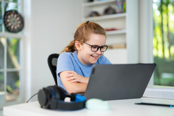 Back to school. Child with laptop at school classroom. Student sitting at desk during distance school class. Smart child study in virtual school.