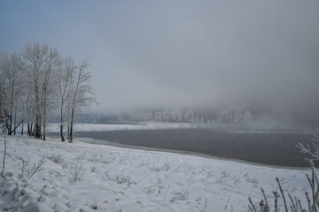 fog over the riverbank in winter